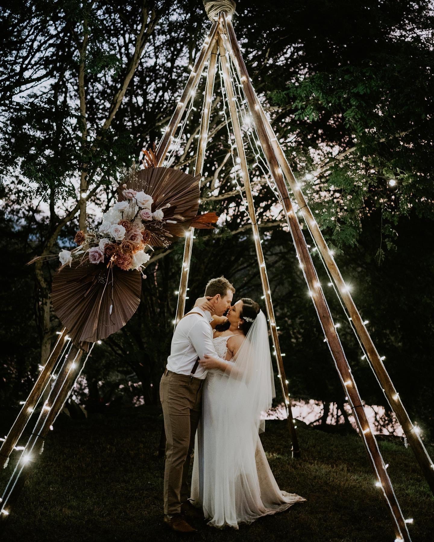 Tipi arbour with fairy lights first kiss