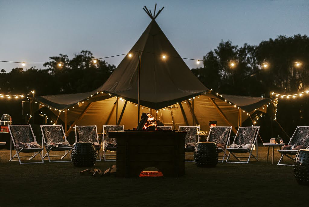 tipi with festoon lighting at night